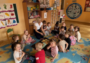 Pani prezentuje różne rodzaje pieczywa a dzieci próbują ich