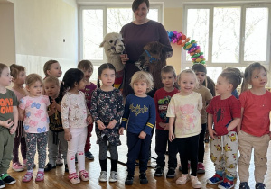 Dzieci z grupy Żabek pozują do zdjęcia z Alpakami