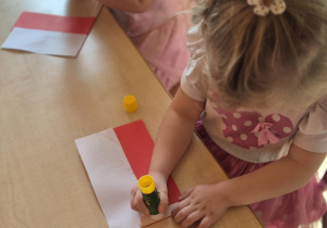 Dziewczynka skleja papier